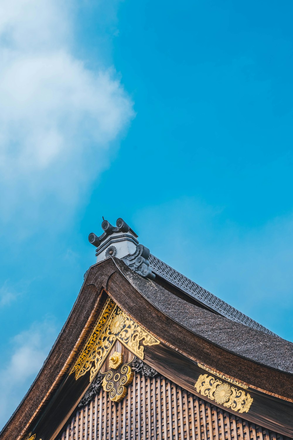 the roof of a building with a blue sky in the background