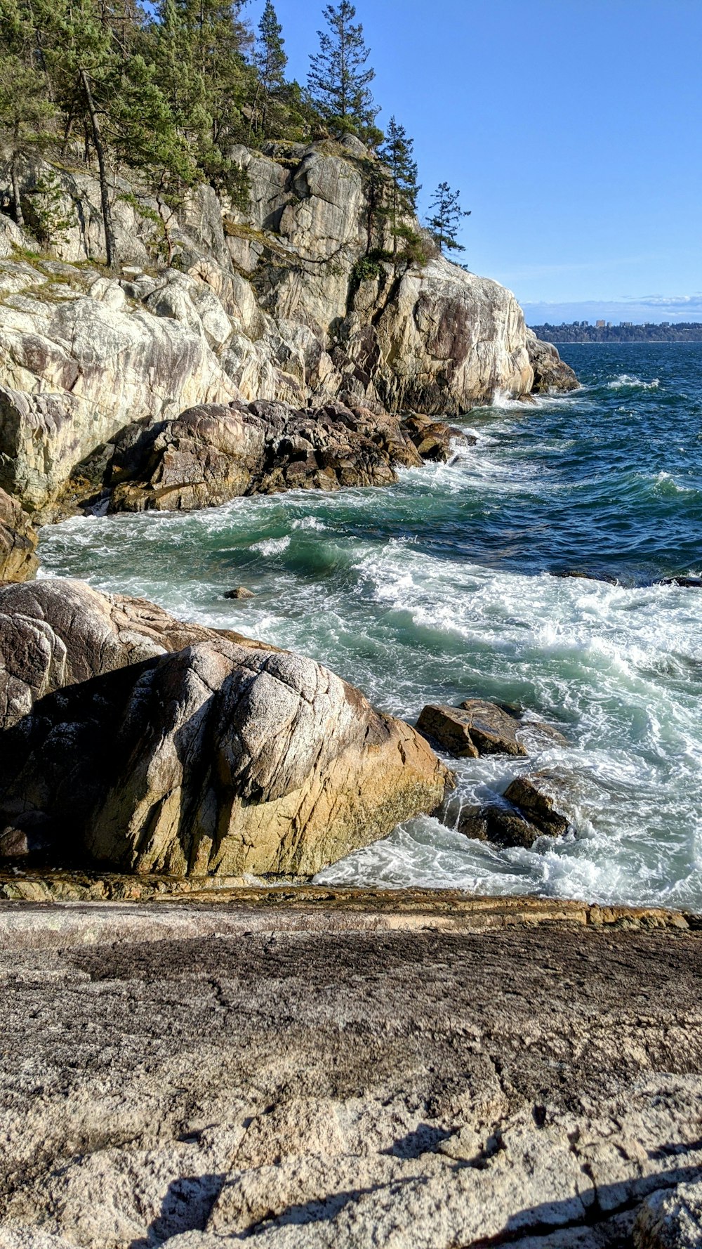 a view of the ocean from a rocky shore