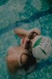a woman in a bikini holding a ball in a swimming pool