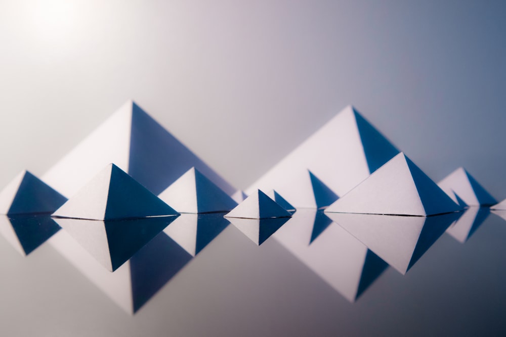 a group of blue and white origami pieces