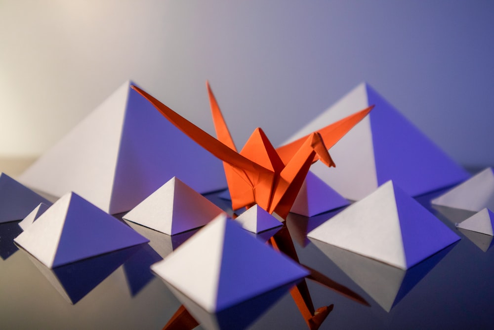 an origami bird is standing out of the crowd