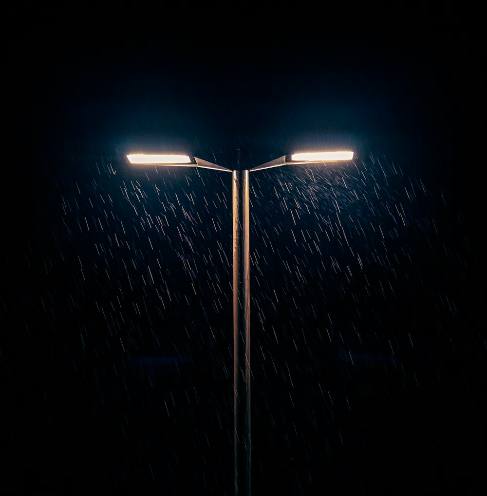 a street light in the rain at night