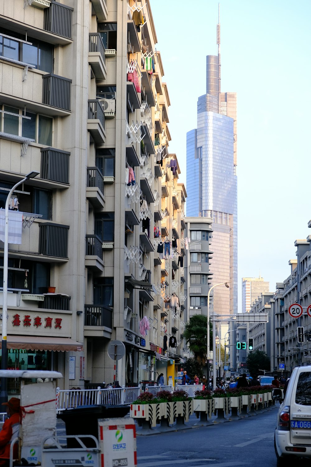 a city street lined with tall buildings with balconies