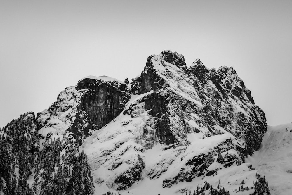 a black and white photo of snow covered mountains