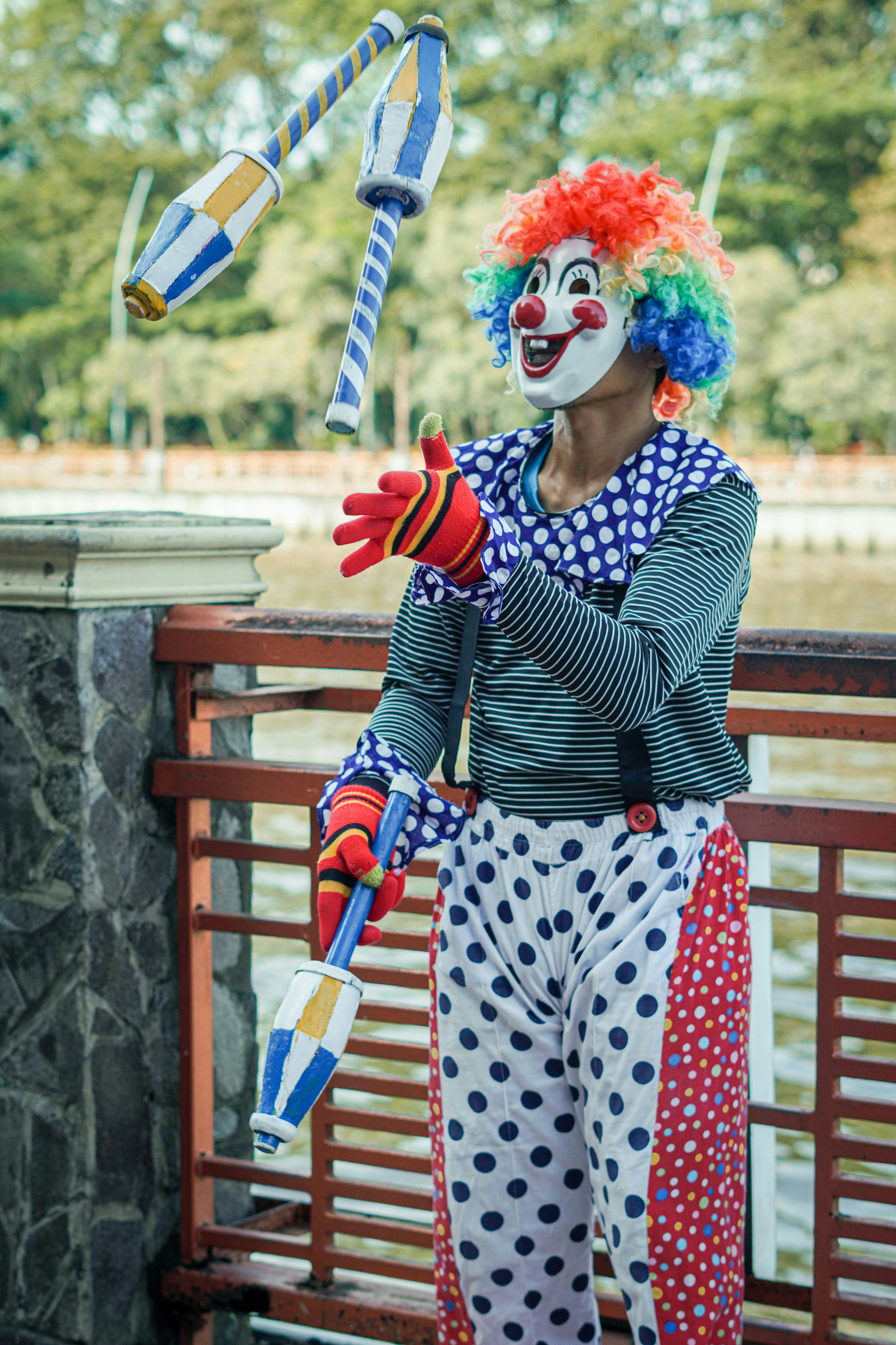 a clown with a clown mask holding a kite