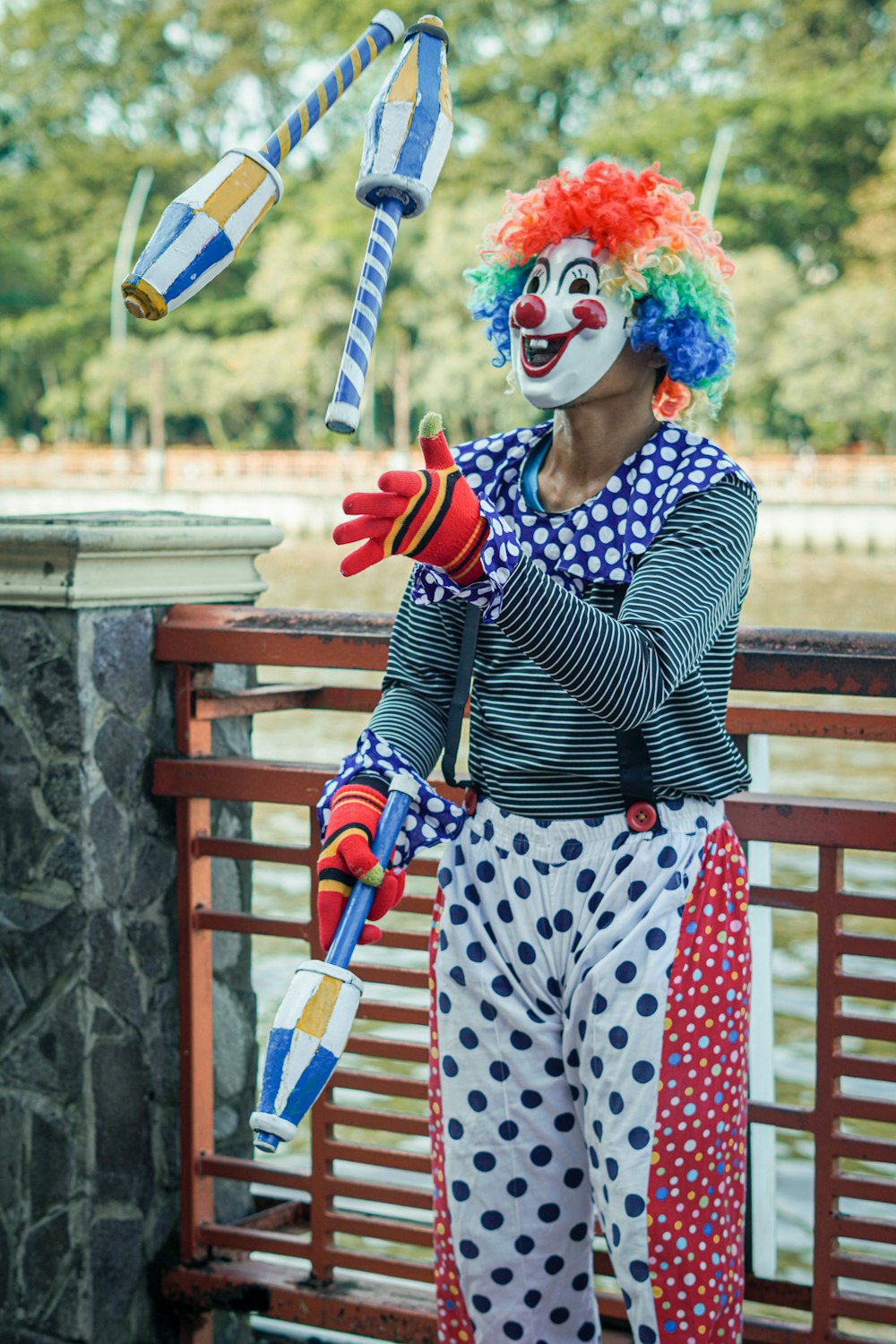 a clown with a clown mask holding a kite