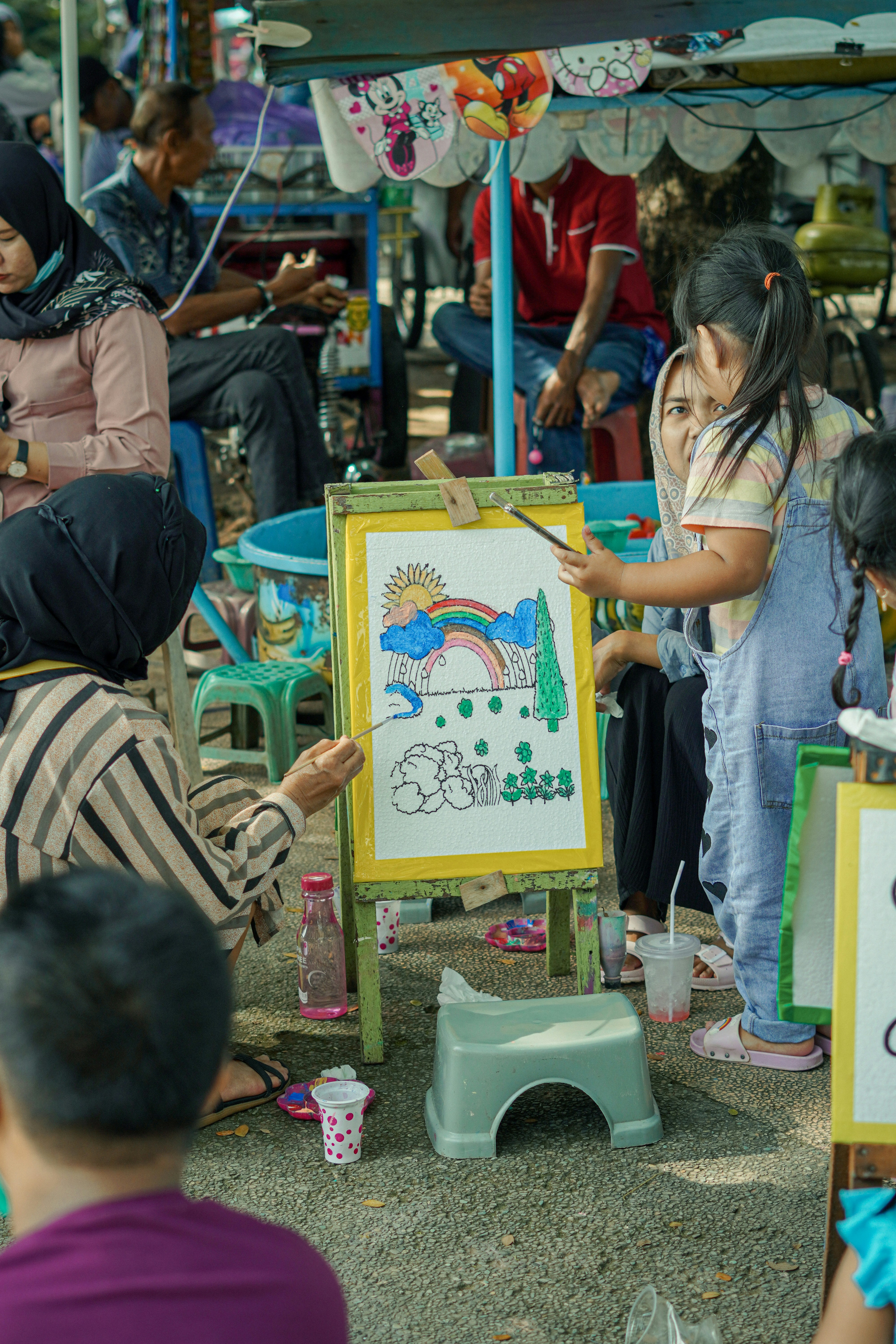 a group of people standing around a white board