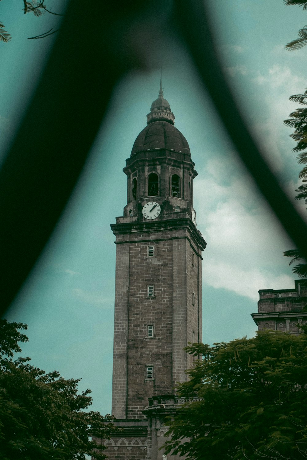 a large clock tower with a sky background