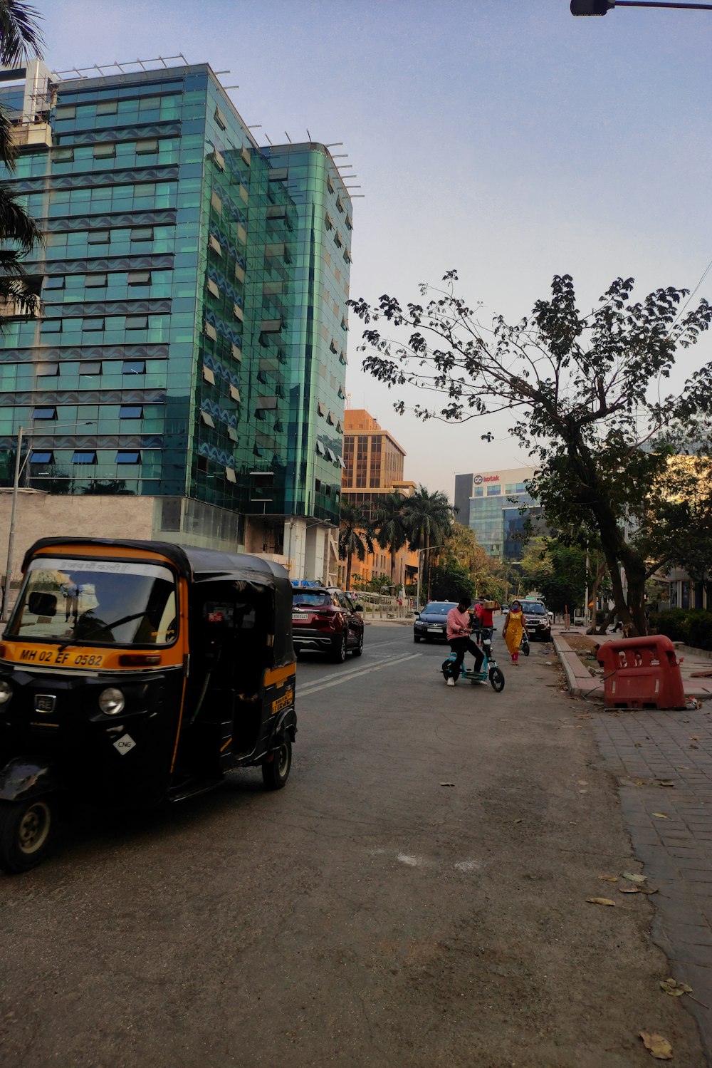 a small car driving down a street next to tall buildings