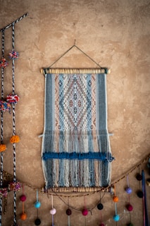a wall hanging with a weaving on it
