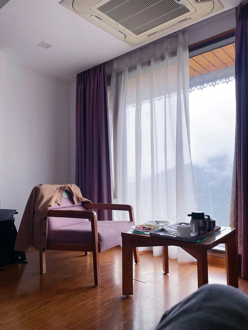 a living room filled with furniture and a window