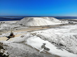 a large pile of snow next to a road