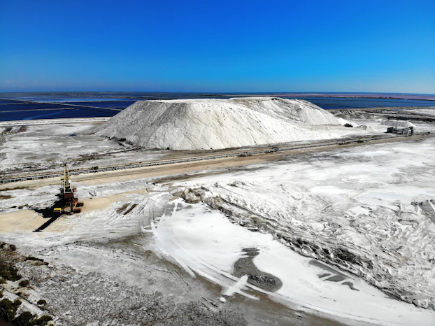 a large pile of snow next to a road