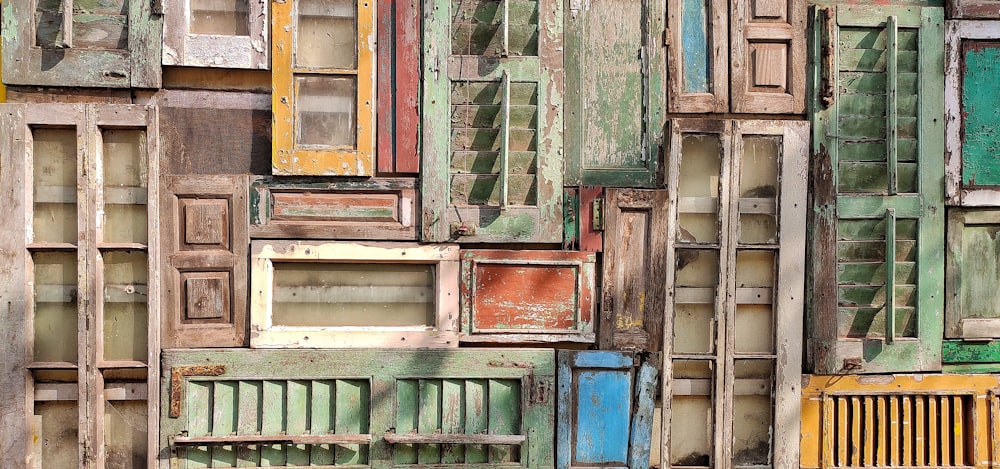 a bunch of different colored doors stacked on top of each other