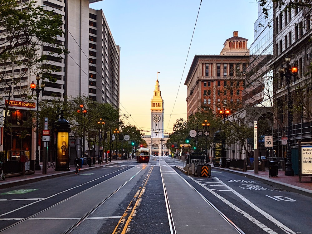 a city street with a clock tower in the background