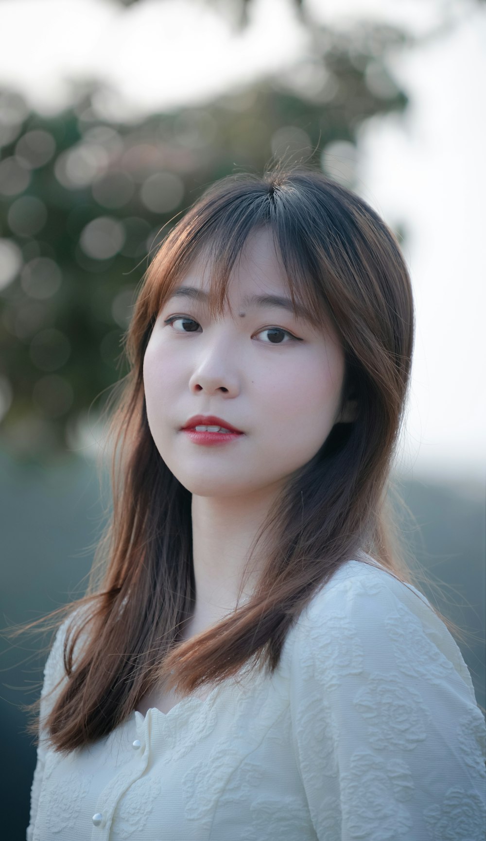 a woman with long hair and a white shirt