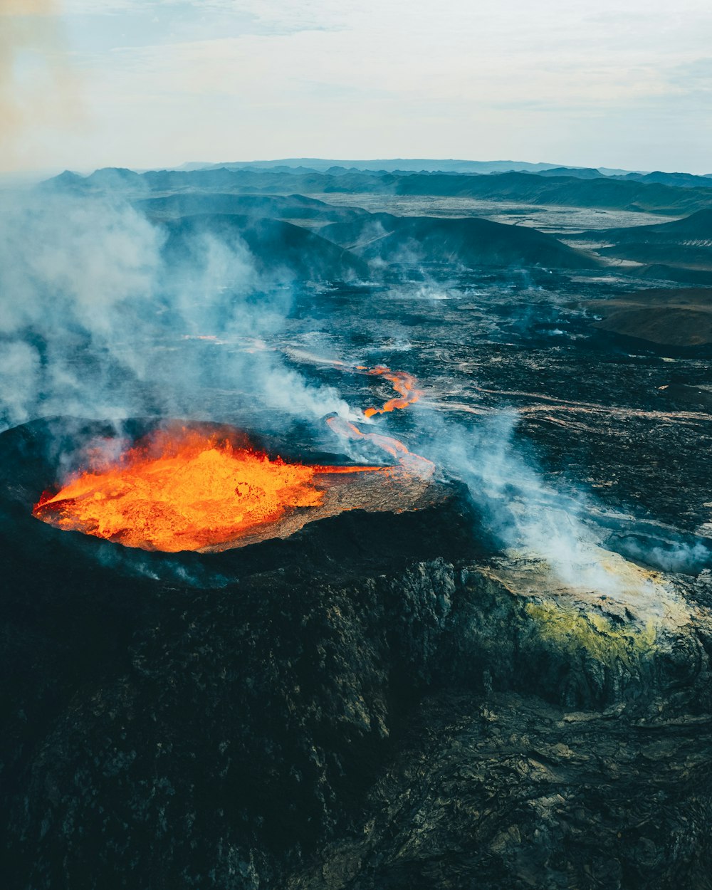 an aerial view of a volcano in the middle of nowhere