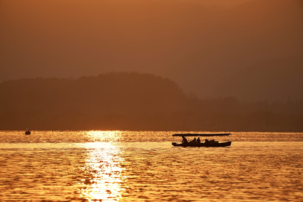 a couple of boats floating on top of a lake