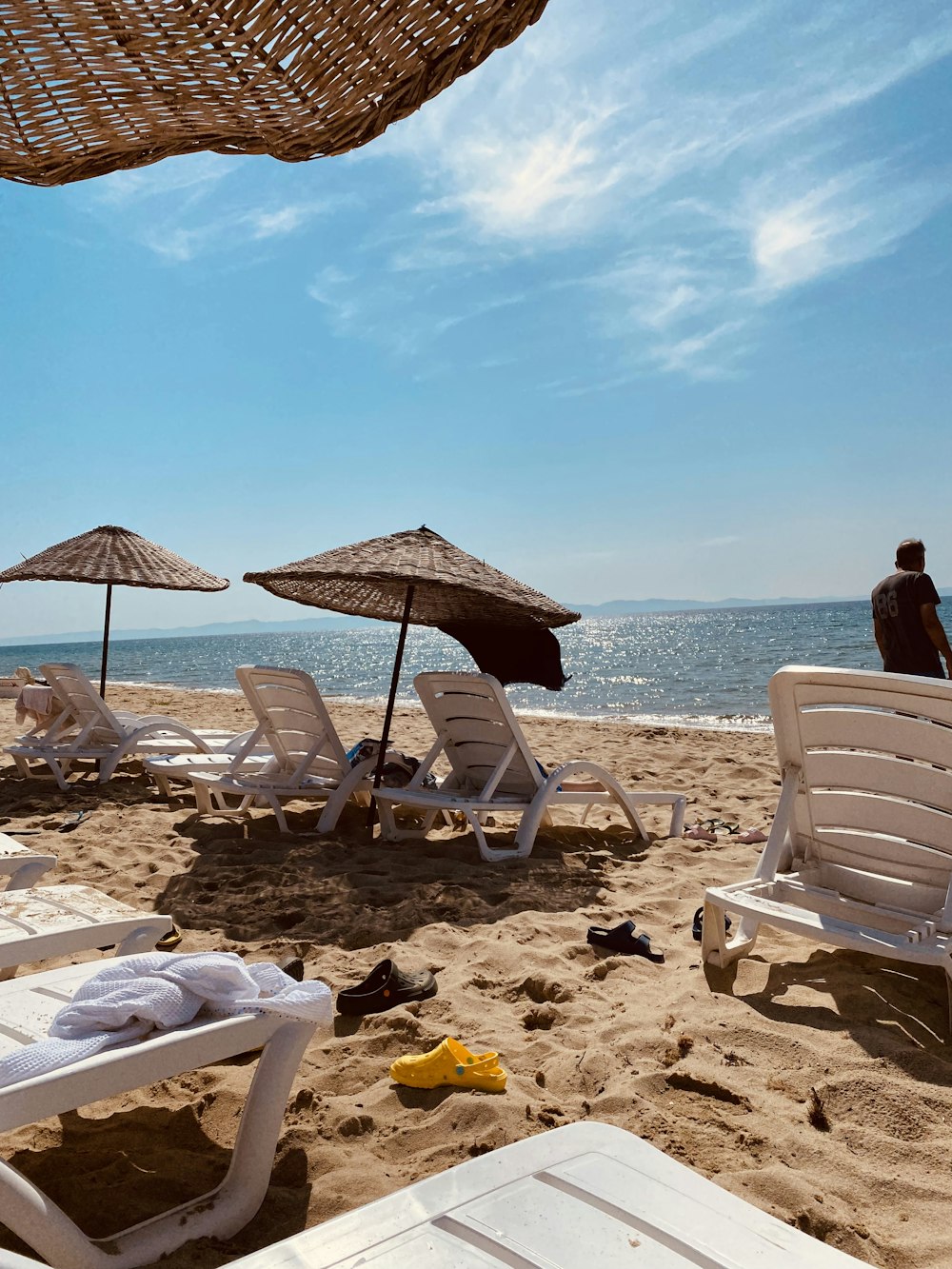 a bunch of lawn chairs and umbrellas on a beach