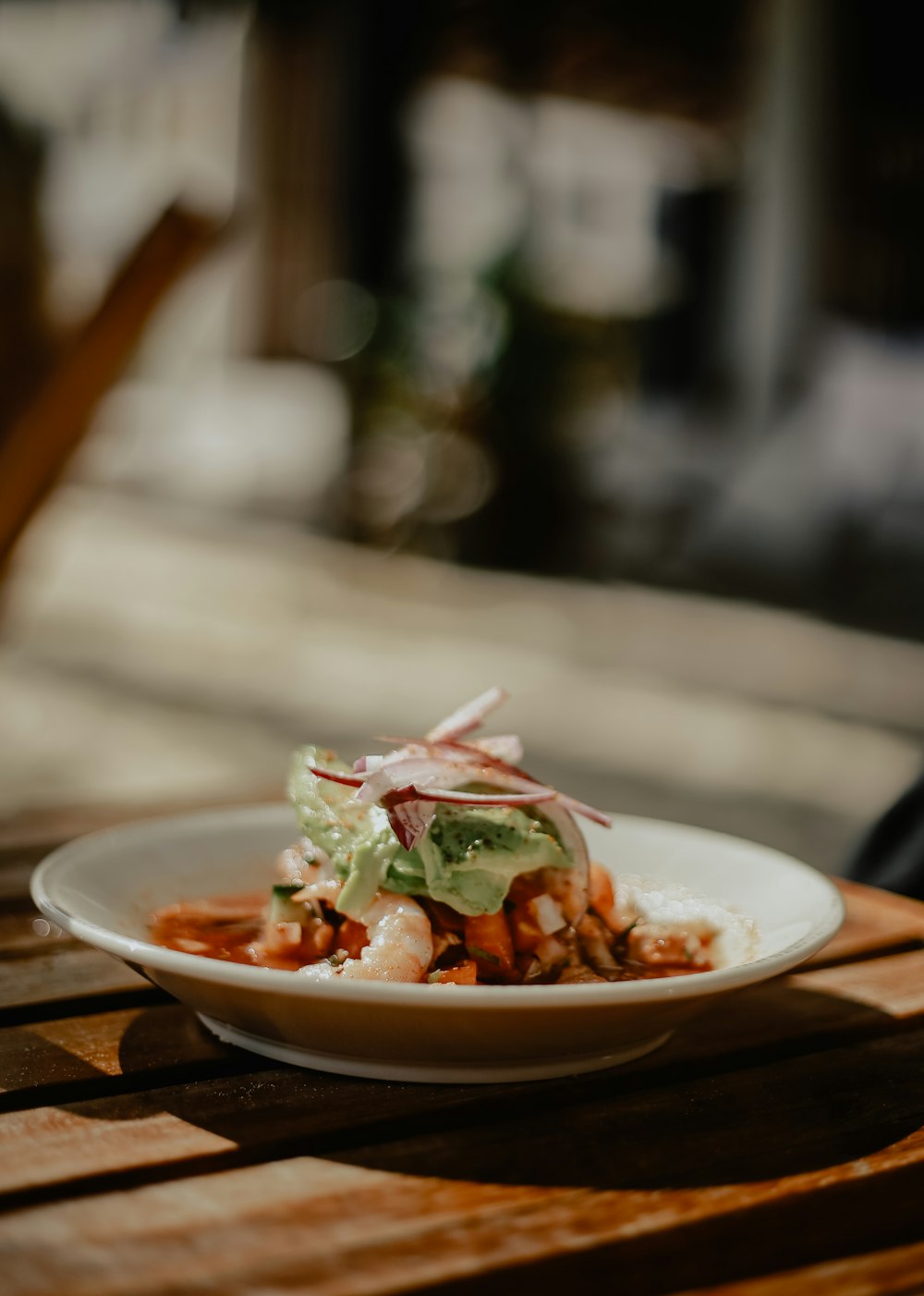 a plate of food sitting on top of a wooden table