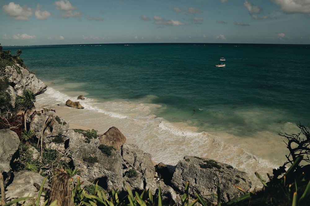 a boat is out on the water near a beach