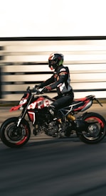 a man riding a motorcycle down a street