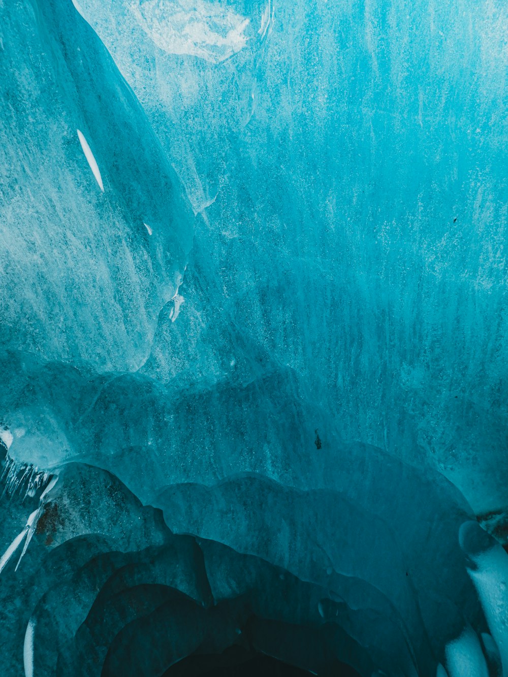 a large ice cave with water flowing down it