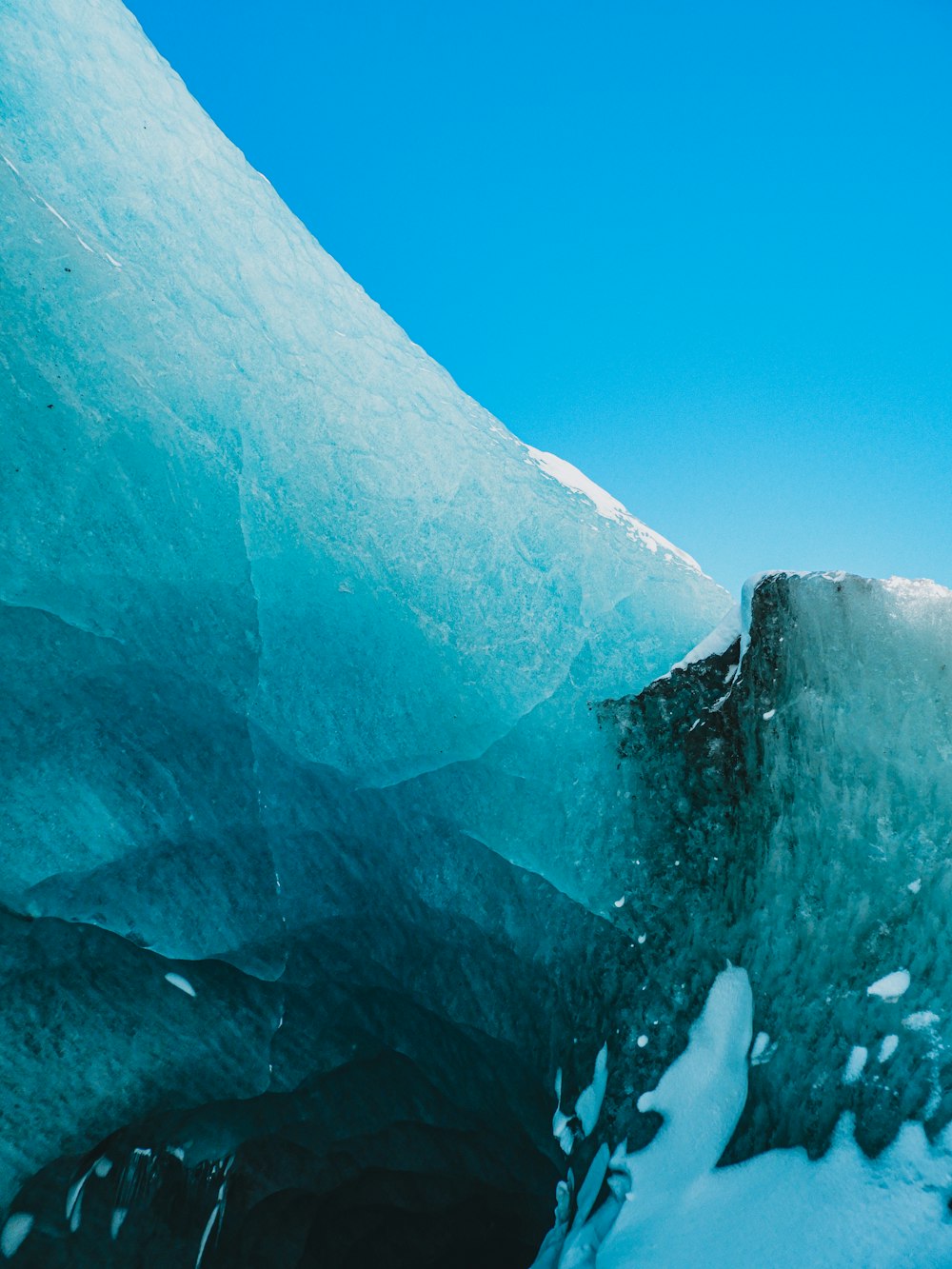 a large iceberg floating in the middle of a lake