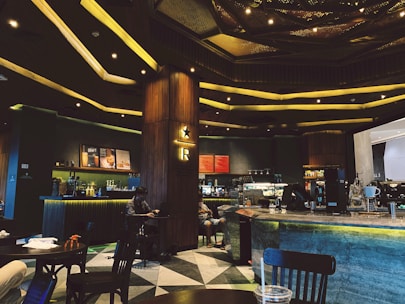 A sleek modern café interior with curved design elements and warm lighting.