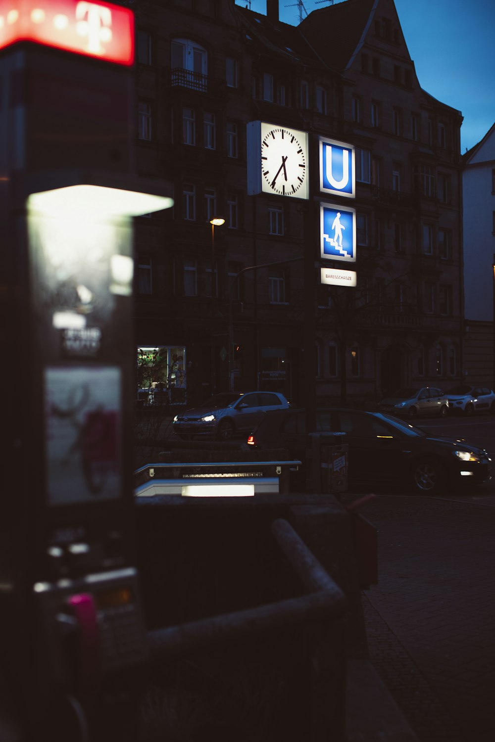 a parking meter sitting next to a tall building