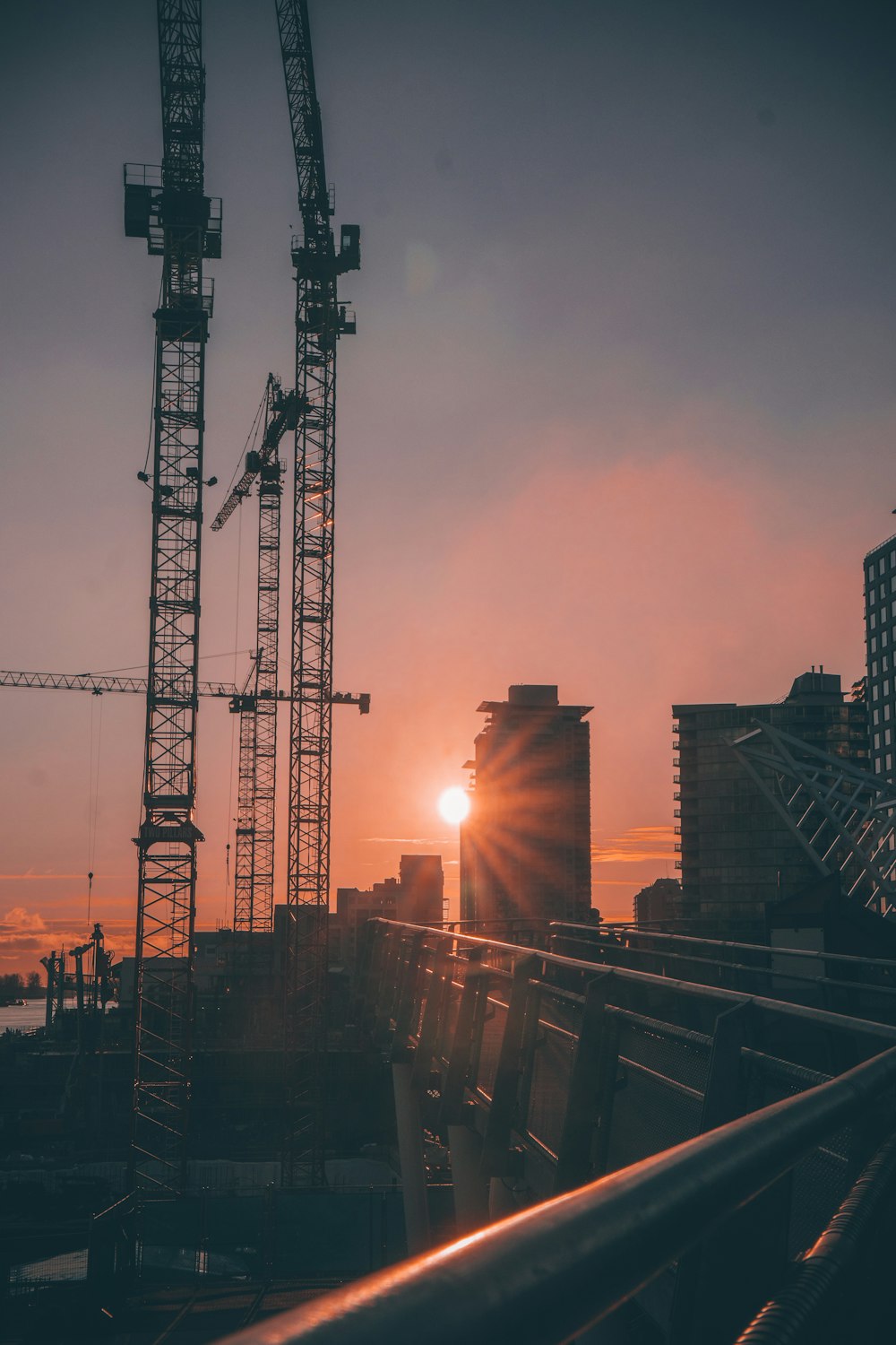 the sun is setting over a construction site