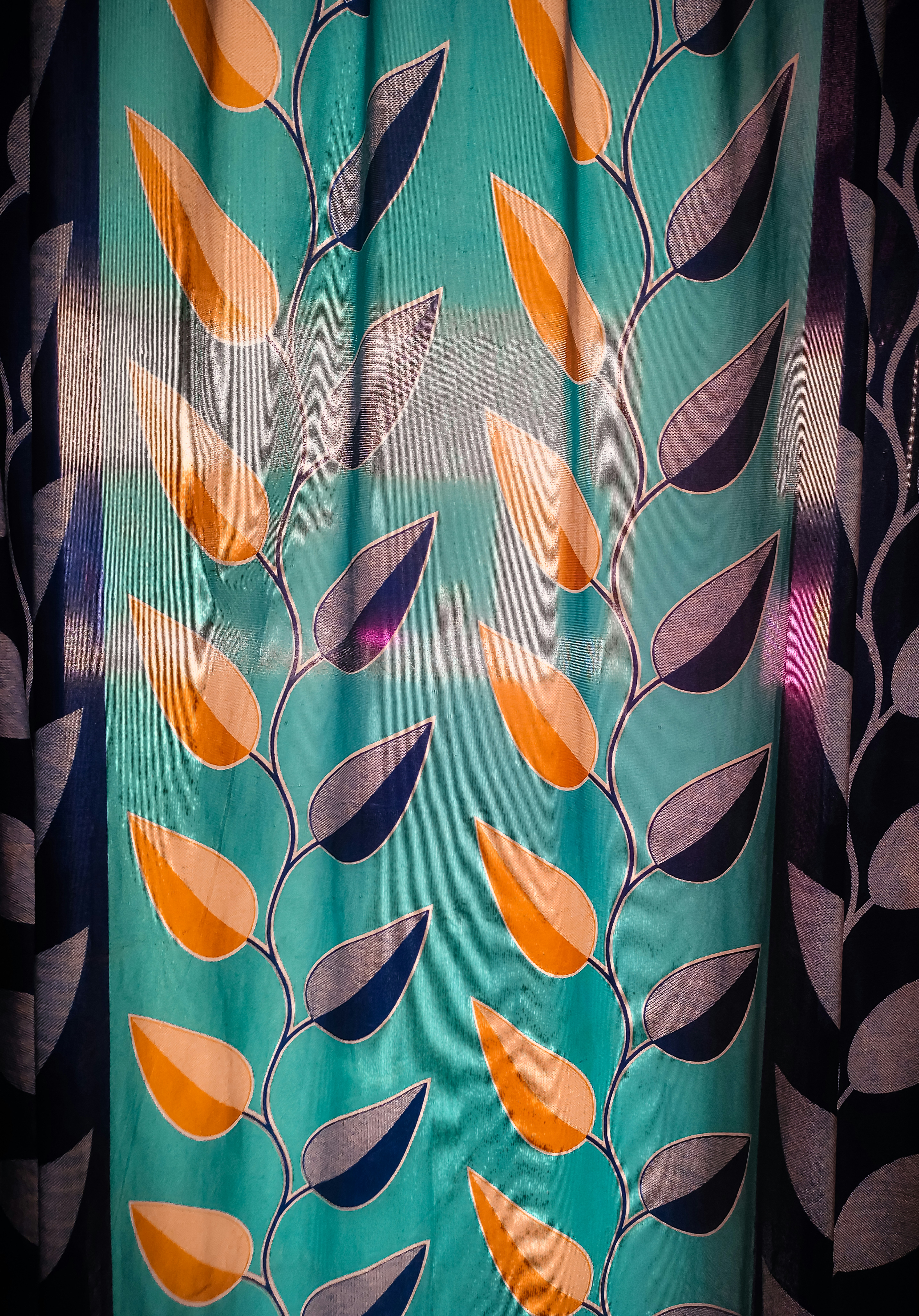 a close up of a curtain with leaves on it