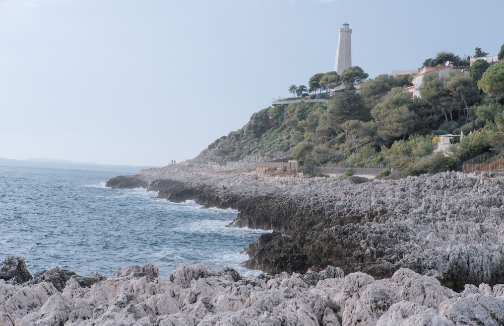 a light house on a hill overlooking the ocean