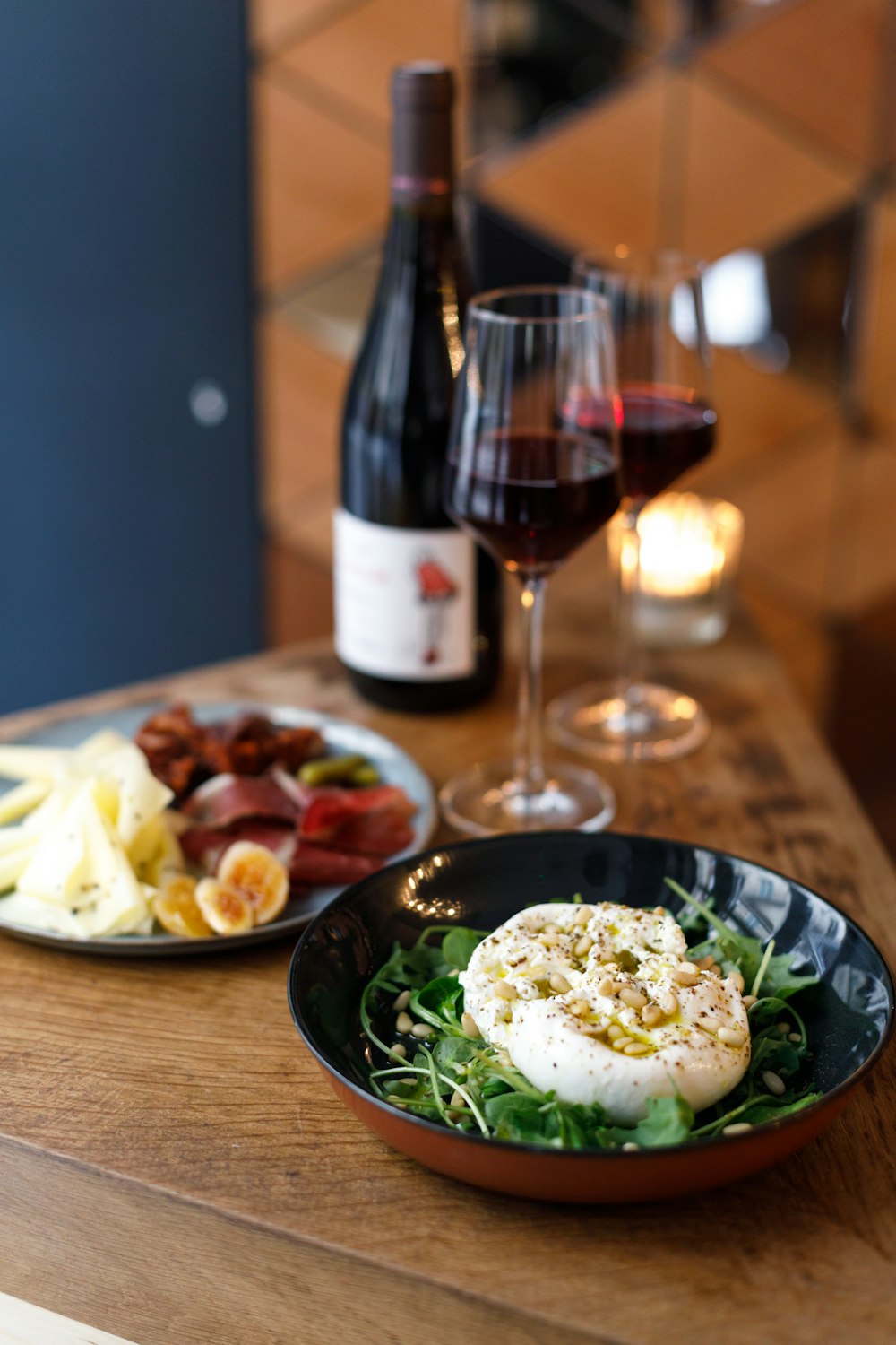 a plate of food and a glass of wine on a table