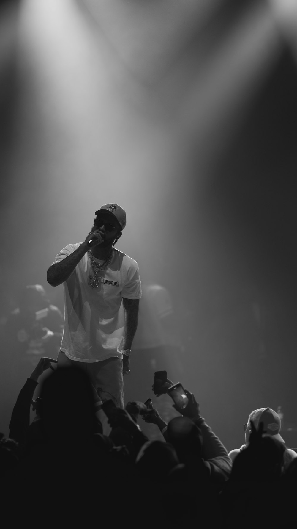 a man standing on top of a stage holding a microphone