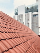 a close up of a roof with a building in the background