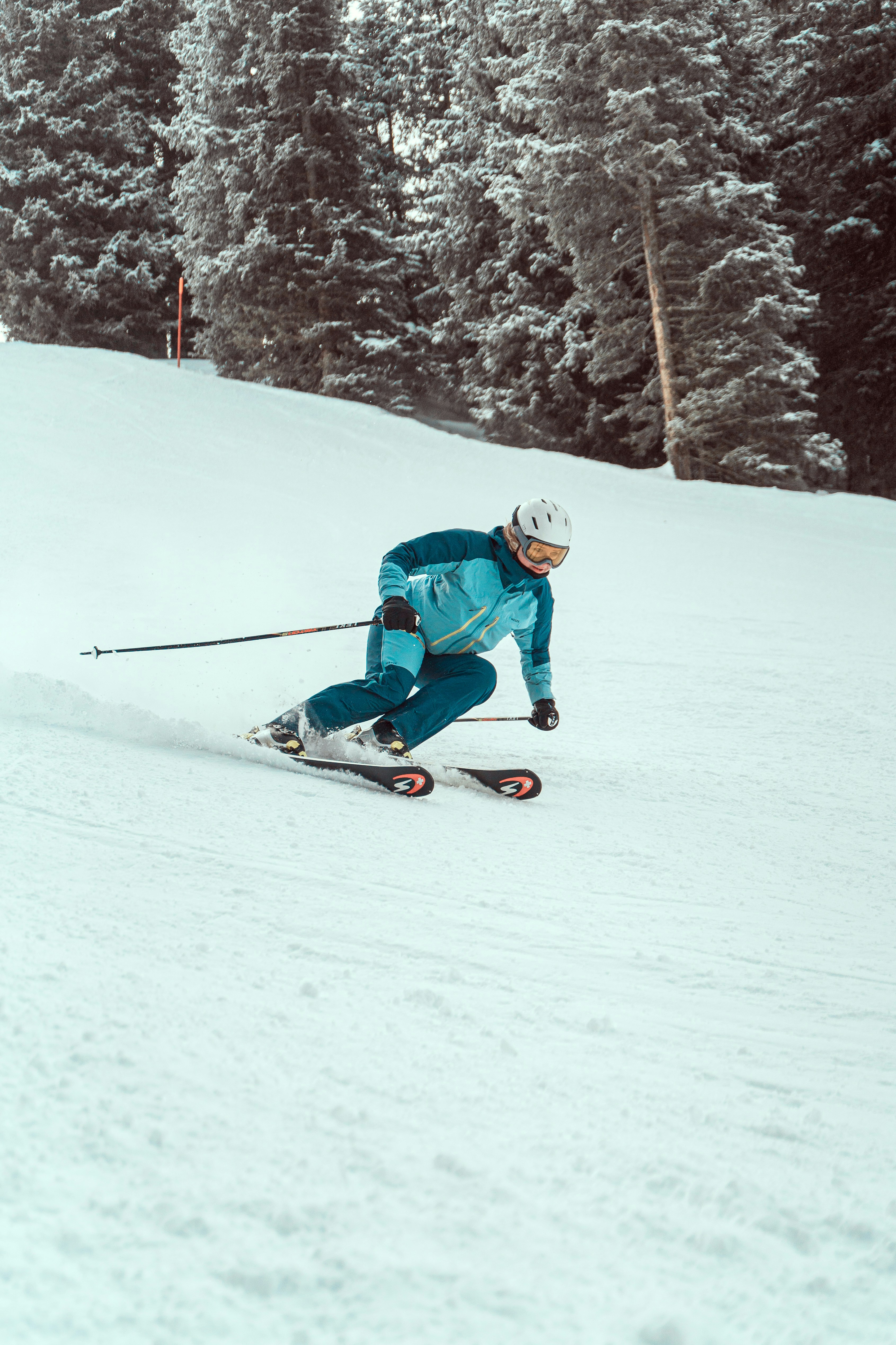 a person riding skis down a snow covered slope