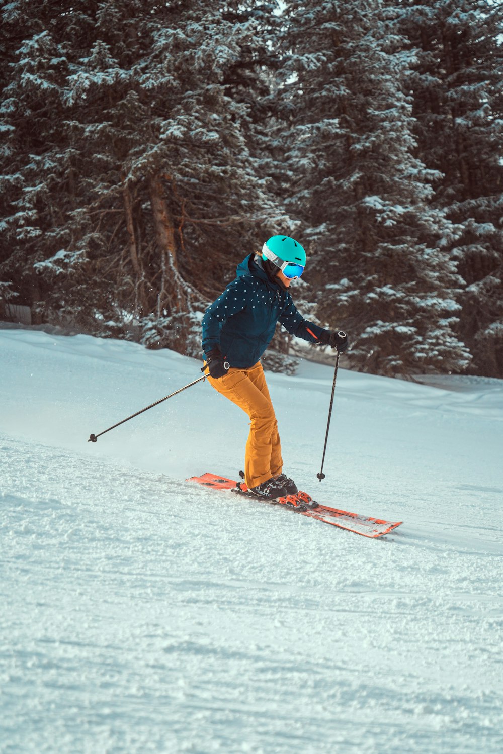 a person riding skis down a snow covered slope