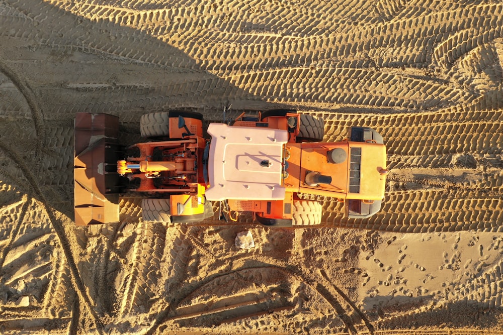 an aerial view of a construction vehicle in the middle of the desert