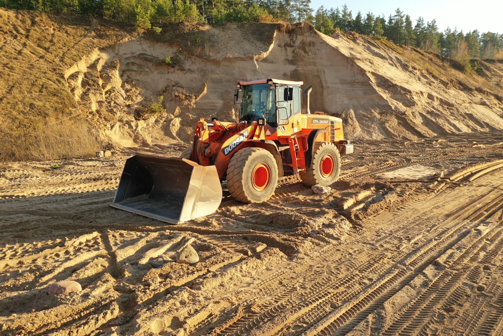 a bulldozer is parked on a dirt road