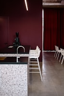 Modern kitchen floor featuring warm terrazzo tiles with natural stone fragments.