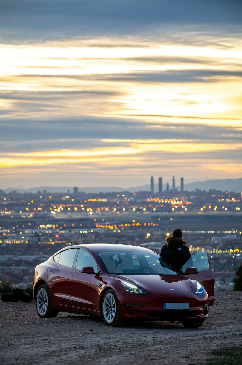 a person sitting on top of a red car