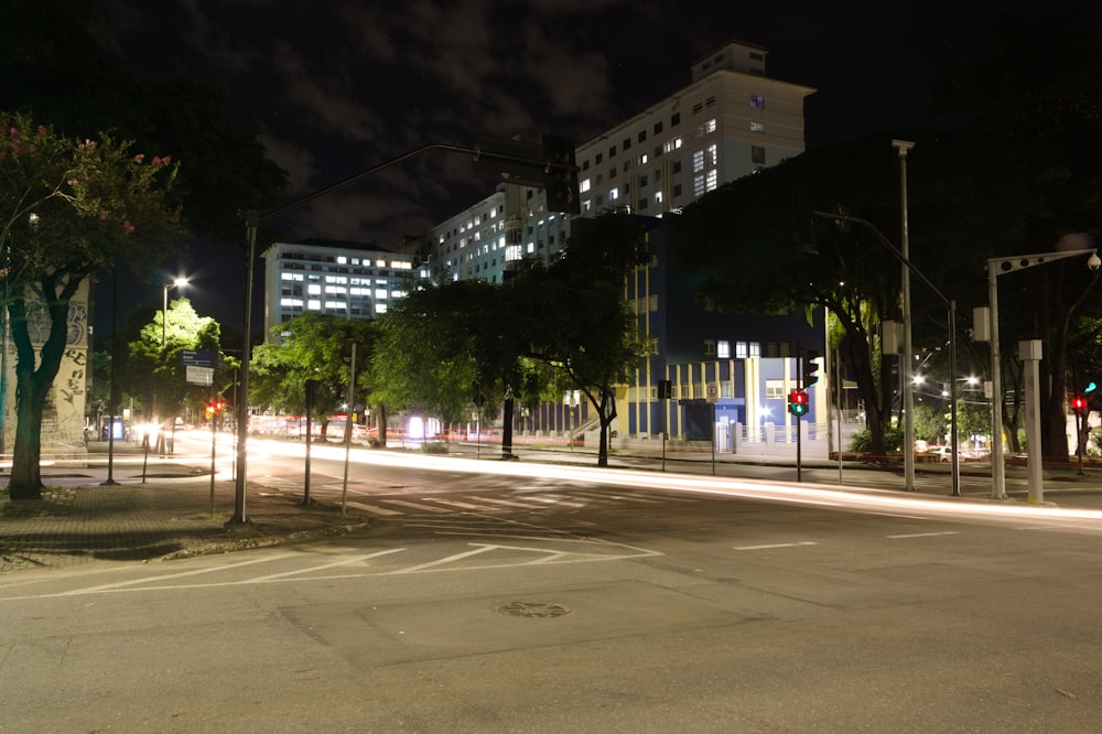 a city street at night with traffic lights