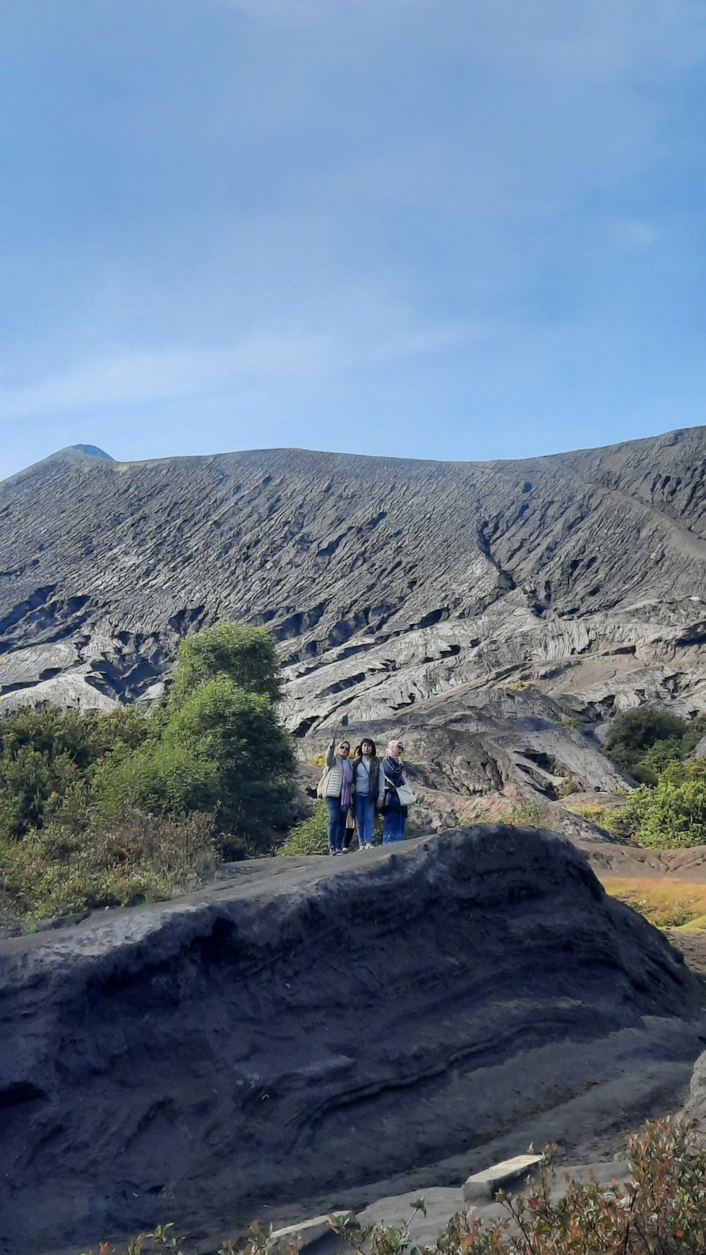 a group of people standing on top of a mountain