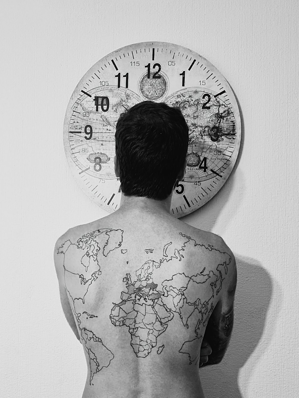 a man with a world map tattoo on his back