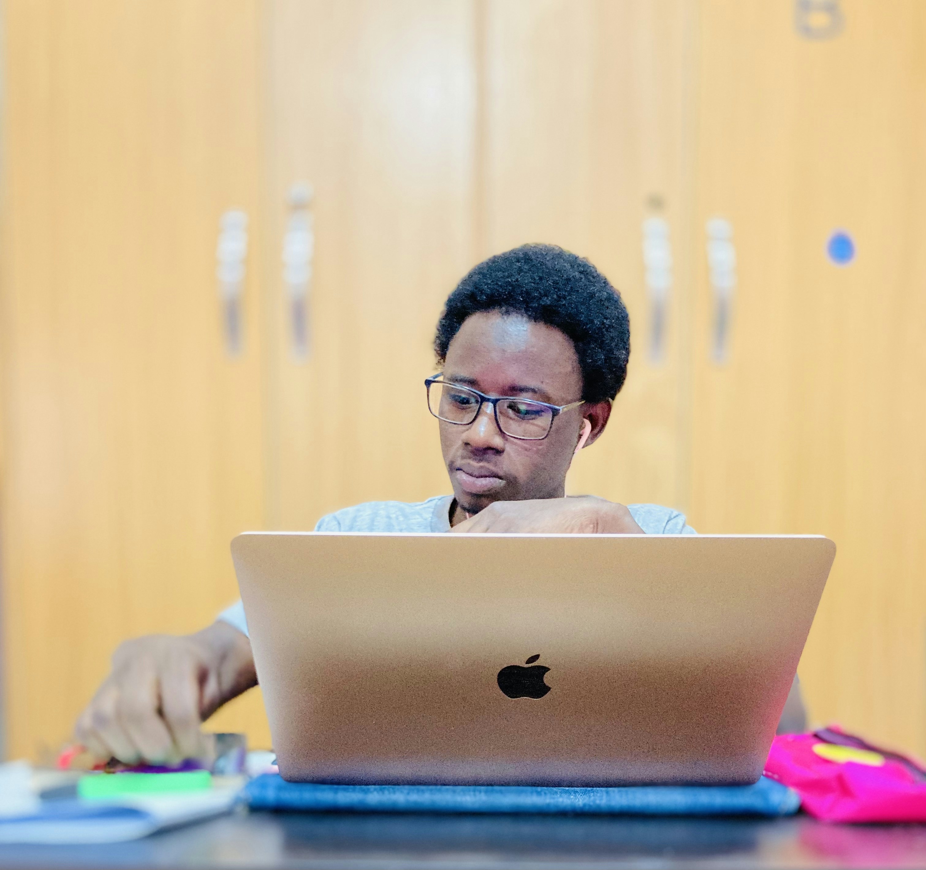 a man sitting at a table using a laptop computer