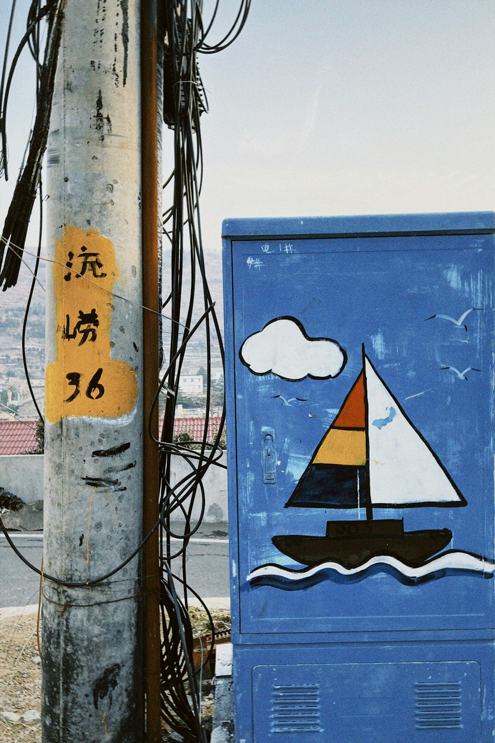 a blue box with a sailboat painted on it