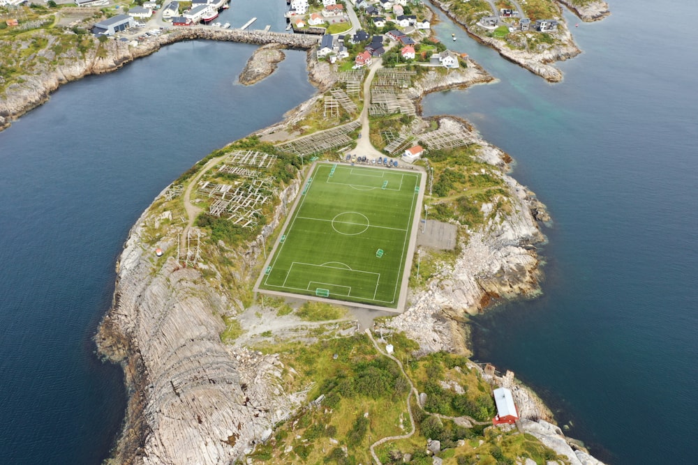 an aerial view of a soccer field in the middle of the ocean