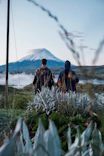 a couple of people that are standing in the grass