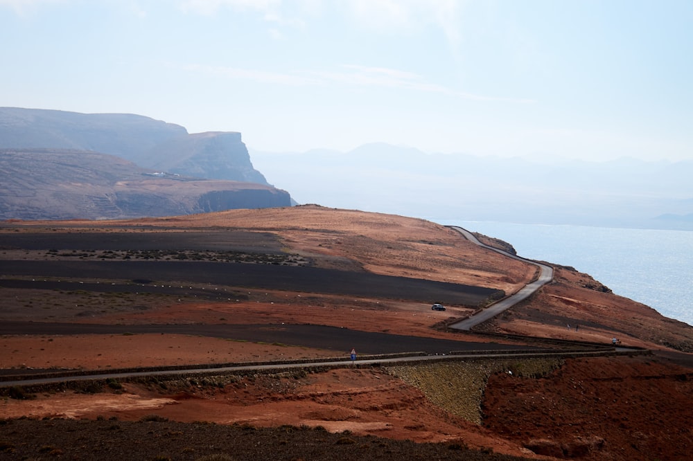 a scenic view of a road on the side of a mountain